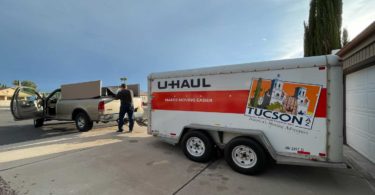 Man standing driveway moving truck