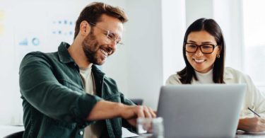 Man and woman watching computer