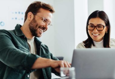 Man and woman watching computer