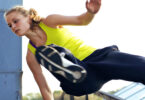 Woman jumping over rail