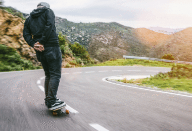 Man skating down road