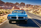 Man driving car desert road