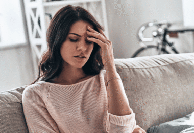 Woman headache couch living room